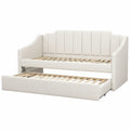Cama nido tapizada en cuero sintético blanco con somier de listones
